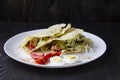 Sliced Ã¢â¬â¹Ã¢â¬â¹chicken with canned  cucumbers and cabbage in sauce, wrapped in pita bread on a white plate. Delicious for lunch or Royalty Free Stock Photo